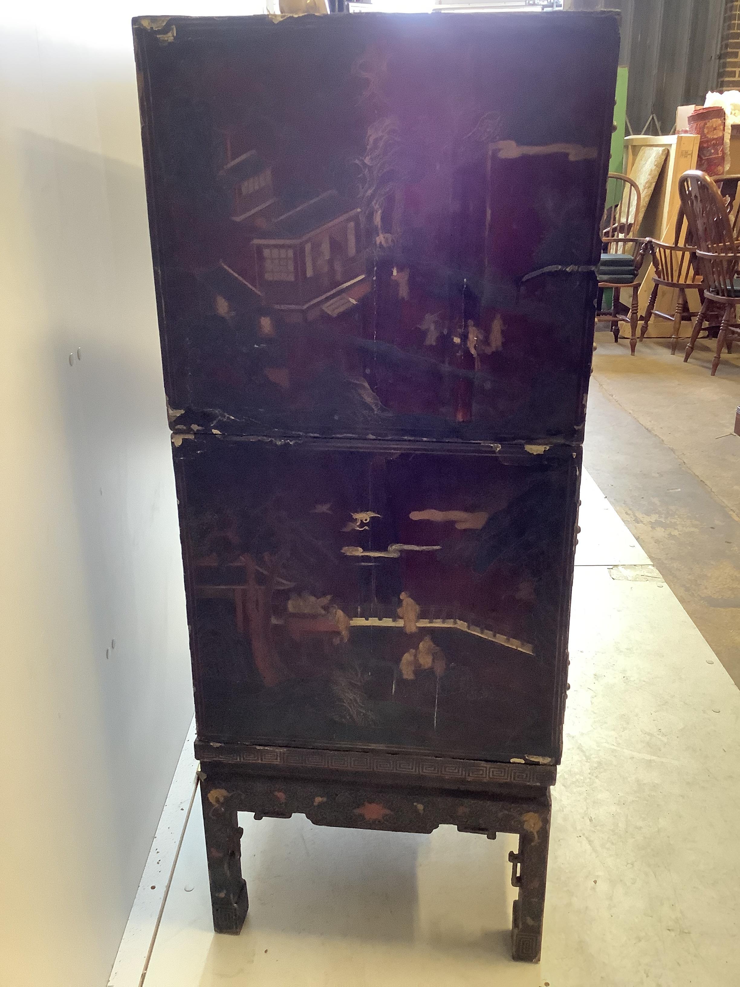 A Chinese lacquered two section cabinet on stand, width 84cm, depth 51cm, height 128cm